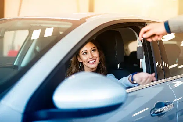 person handing over car keys